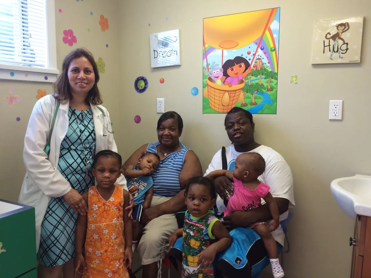 Modern pediatric examination room with child-friendly medical equipment and comfortable atmosphere